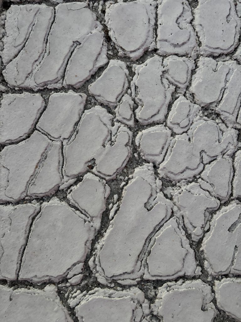cracked pavement with lines